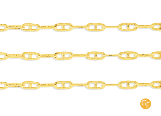 A close-up image of a textured gold mariner chain with a focus on the metallic texture and color.