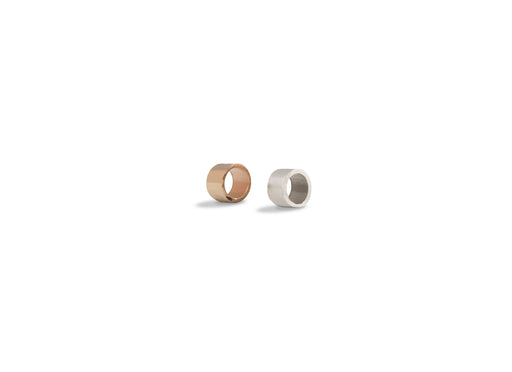 Two bangle charm spacers, one with a rose gold finish and the other with a silver finish, displayed against a white background.