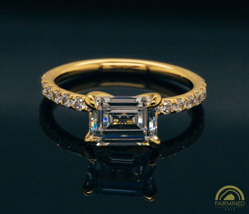 Photo of East-West Emerald Cut Diamond Pavé Engagement Ring Semi-Mount in Fairmined Yellow Gold from RIVA Precision