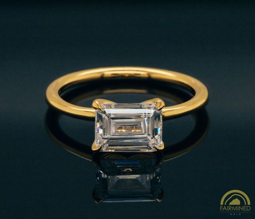 Photo of East-West Emerald Cut Diamond Solitaire Engagement Ring Mounting in Fairmined Yellow Gold from RIVA Precision
