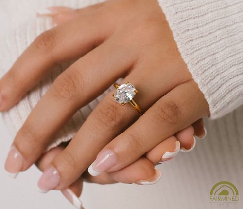 Model wearing Oval Diamond Solitaire Engagement Ring Mounting in Fairmined Yellow Gold from RIVA Precision