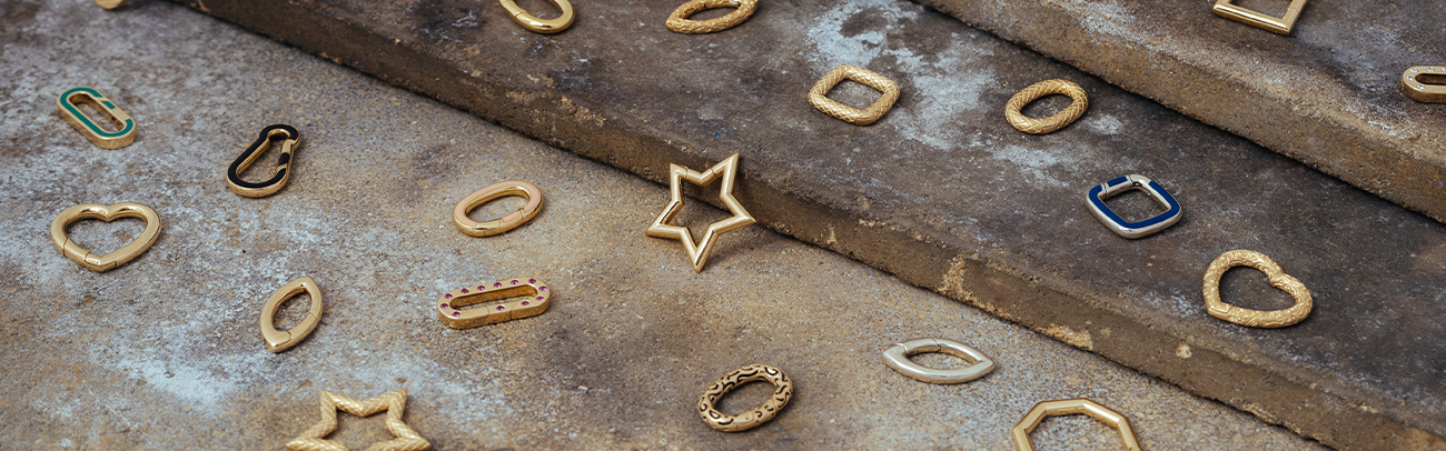Invisible Clasps charms scattered on table