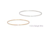 Two bangle wires, one gold and one silver, on a white background.