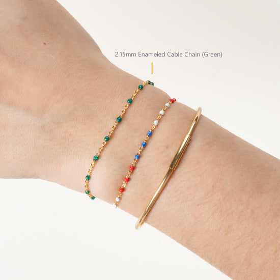 Close-up of a wrist wearing three bracelets on a white background