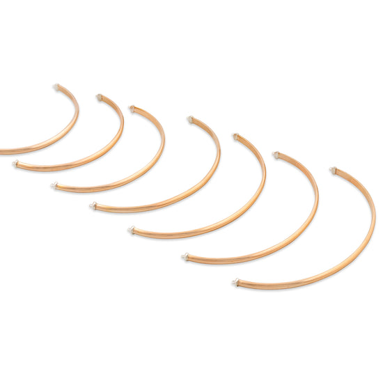 Set of gold hoop earrings on a white background