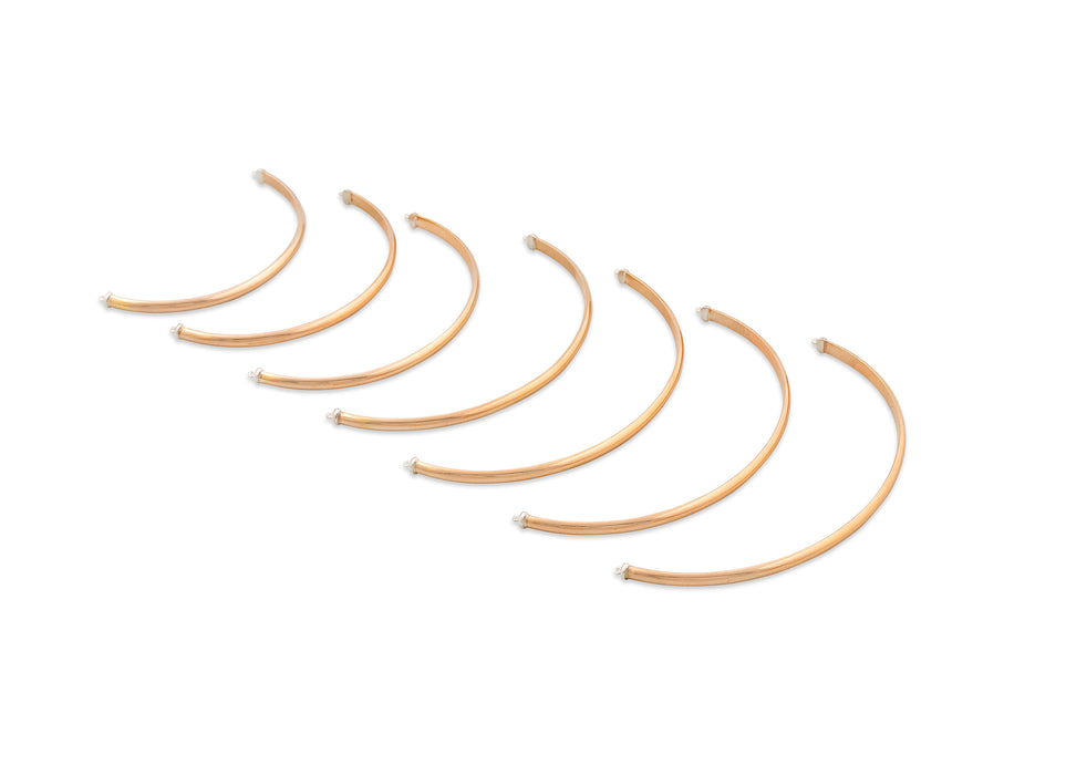 Set of gold hoop earrings on a white background