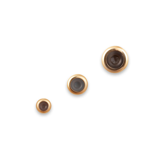 Three gold grip spacers on a white background