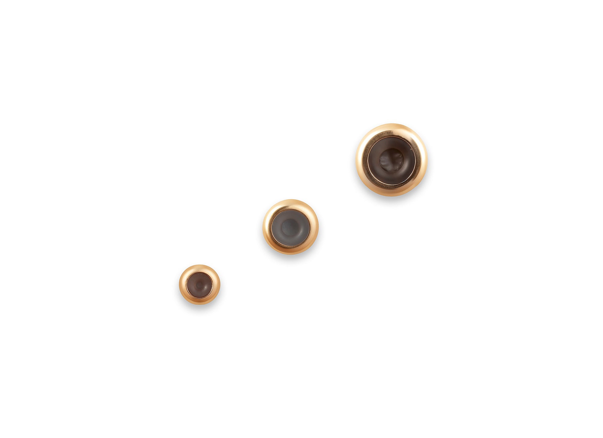 Three gold grip spacers on a white background