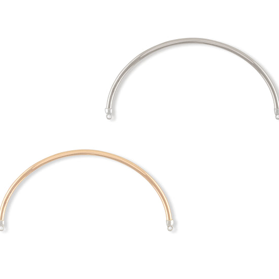 Two gold and silver bracelets on a white background