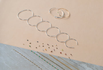 Set of silver permanent cuffs on a beige background