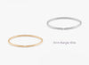 Gold and silver 3mm bangle wires on a white background