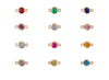 Gold jewelry connectors with colorful gemstones on a white background
