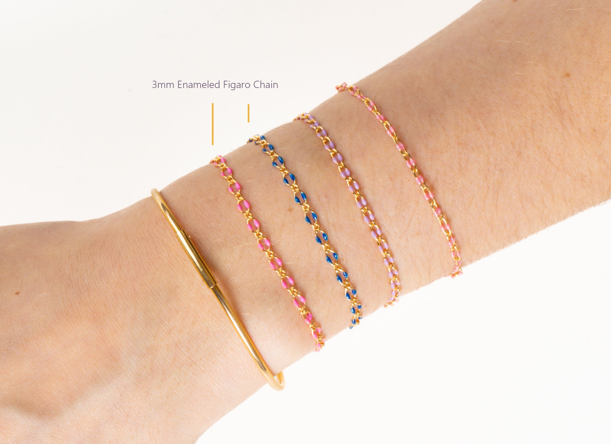 Close-up of a wrist wearing a gold bracelet and colorful beaded bracelets on a white background