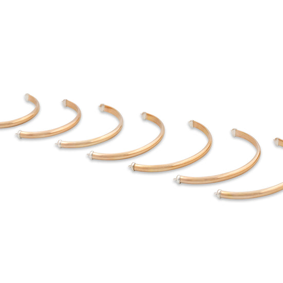 Set of gold hoop earrings on a white background