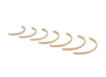 Set of gold hoop earrings on a white background