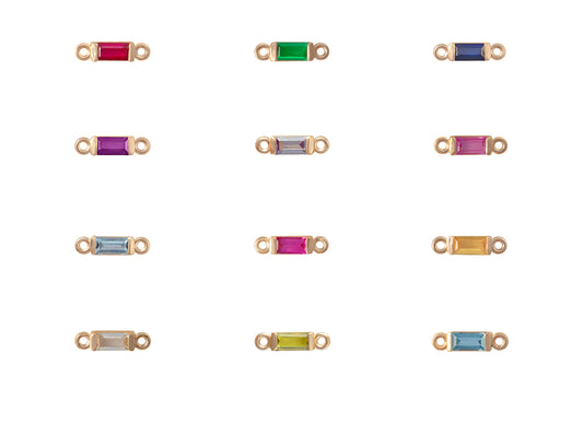 Gold jewelry connectors with colored gemstones on a white background