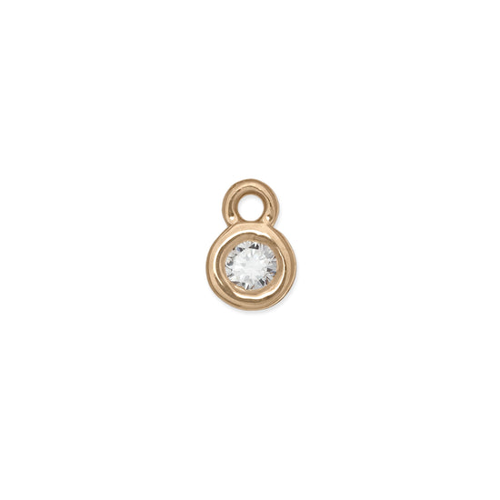 A bezel-set birthstone charm 14k gold and a clear gemstone.