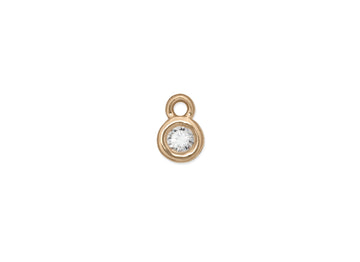 A bezel-set birthstone charm 14k gold and a clear gemstone.