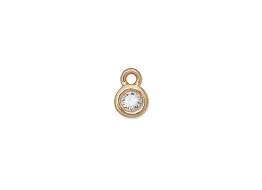 A bezel-set birthstone charm 14k gold and a clear gemstone.