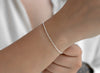 Silver bracelet on a wrist with a blurred background