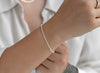 Silver bracelet on a wrist with a blurred background