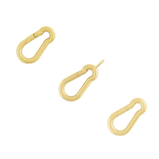 Three carabiner-shaped invisible clasps made of gold, displayed against a white background.