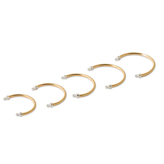 Set of permanent Cuff Rings with small pearls on a white background