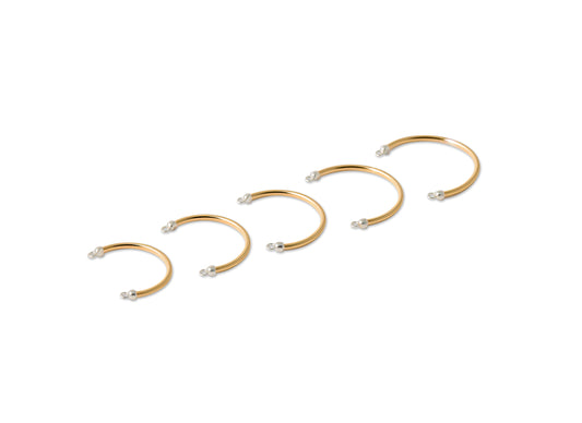 Set of permanent Cuff Rings with small pearls on a white background