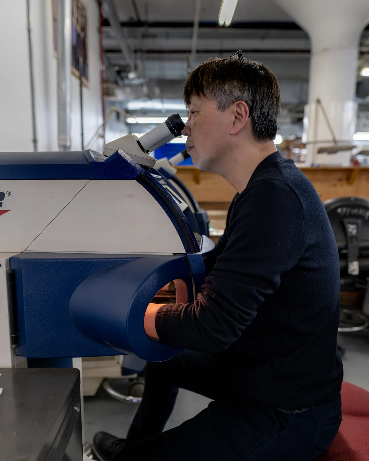 Person using a large machine in an industrial setting
