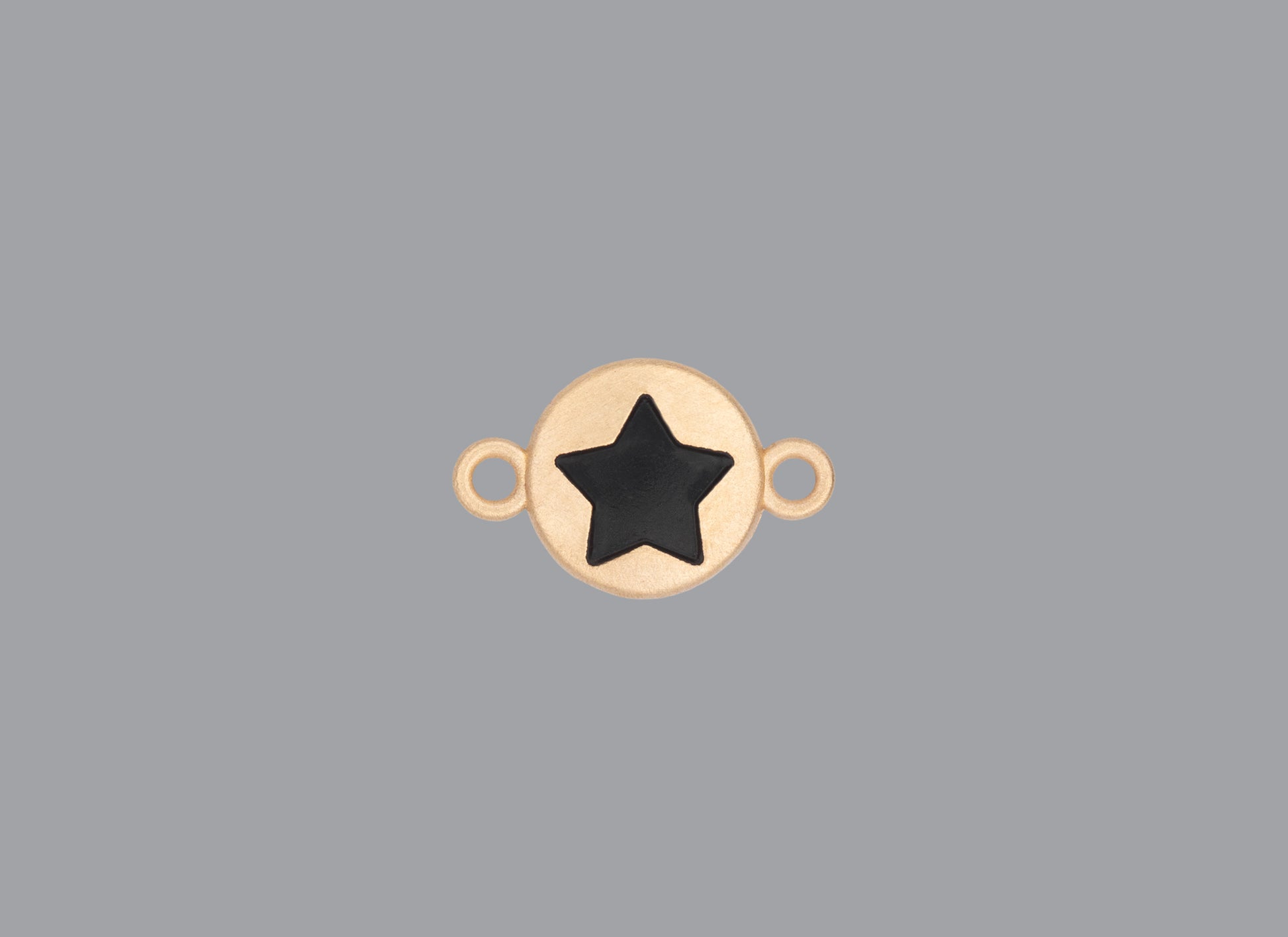 Round emoji connector in gold with a star engraving on gray background