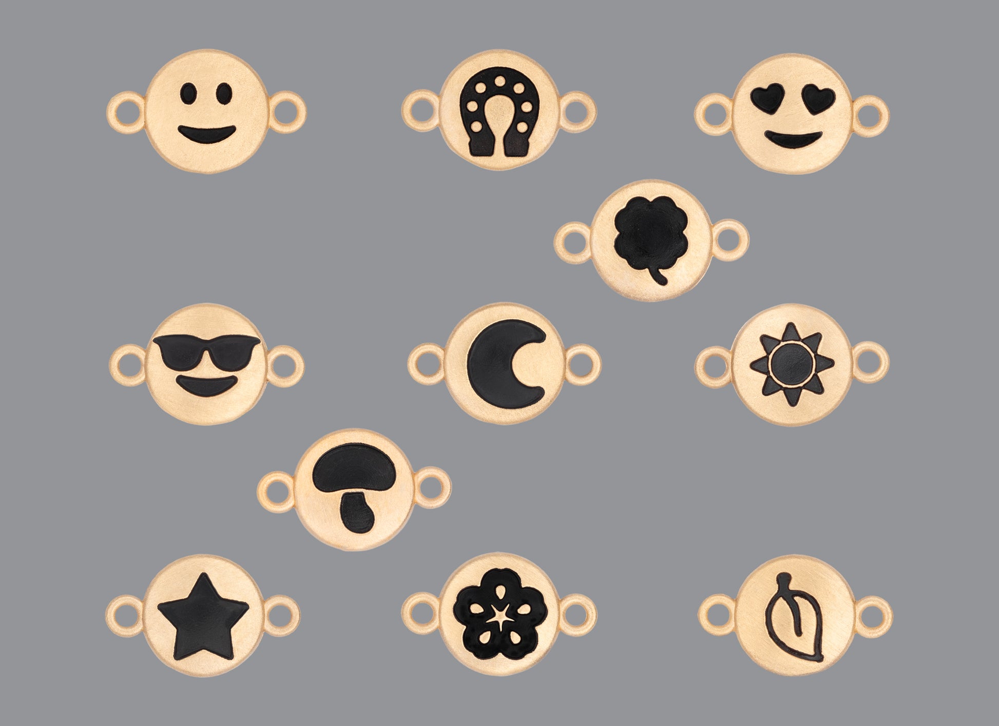 A collection of round emoji connectors with a satin finish in various designs, including smiley faces, hearts, stars, and floral patterns.
