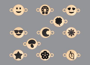A collection of round emoji connectors with a satin finish in various designs, including smiley faces, hearts, stars, and floral patterns.