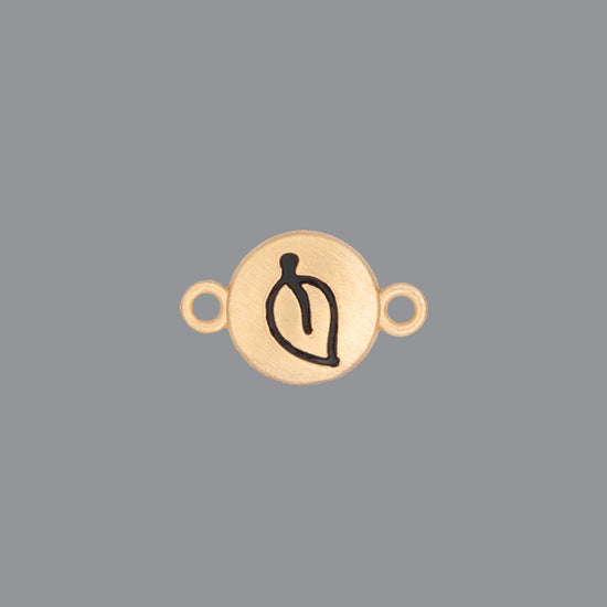 Round emoji connector in gold with a leaf engraving on gray background