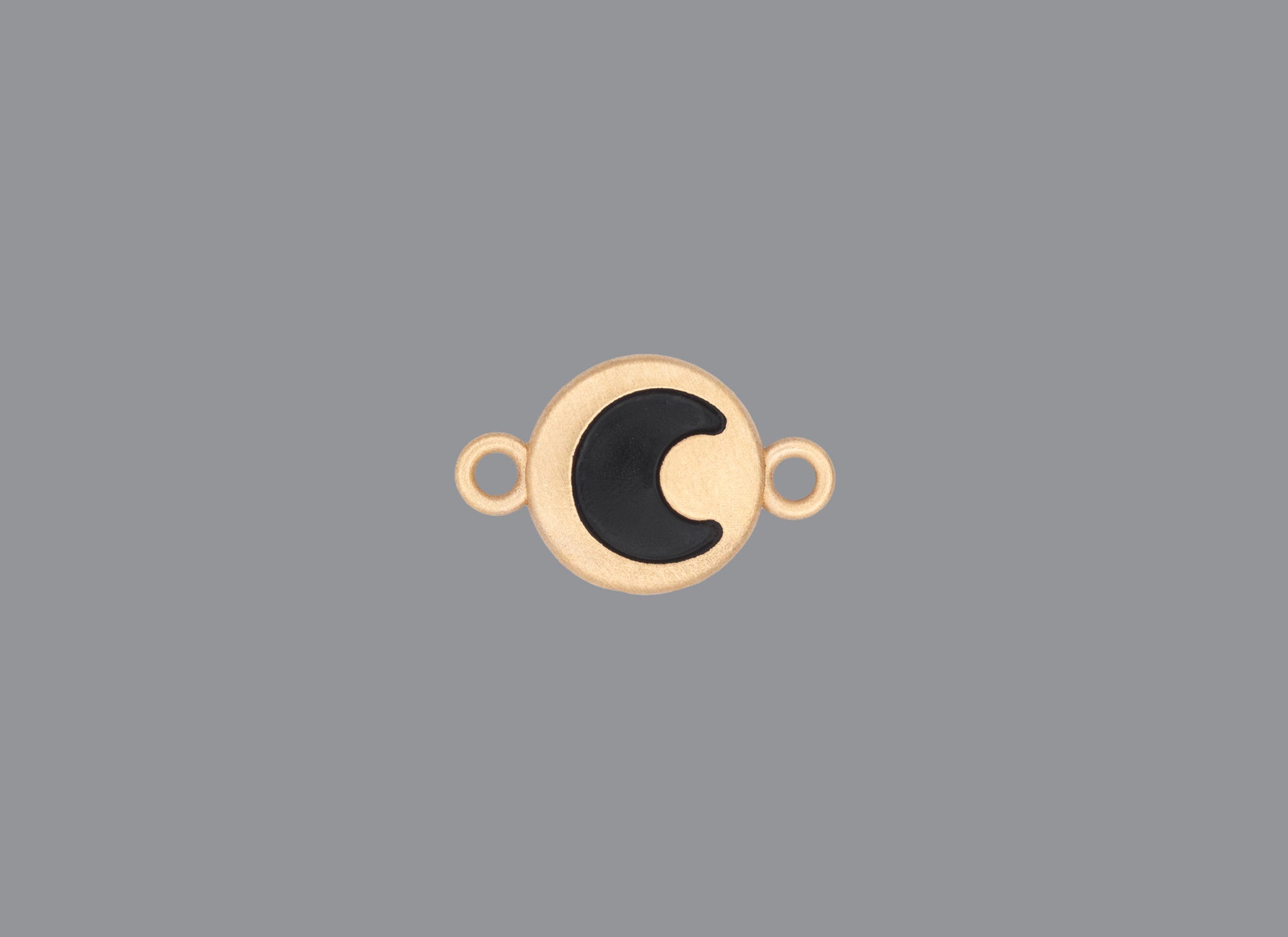 Round emoji connector in gold with a moon engraving on gray background