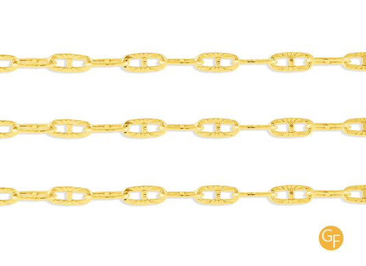 A close-up image of a textured gold mariner chain with a focus on the metallic texture and color.
