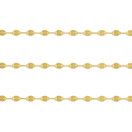 A close-up image of a gold-filled hammered paperclip chain with intricate details on the texture.