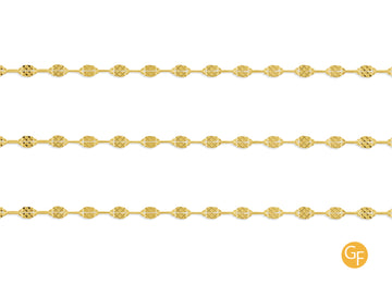 A close-up image of a gold-filled hammered paperclip chain with intricate details on the texture.