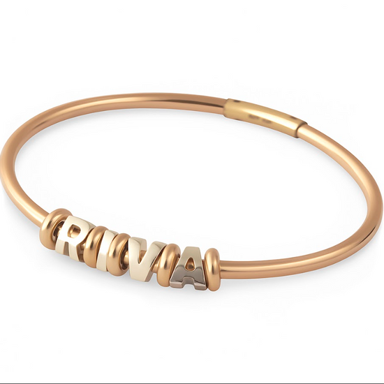 Rose gold bracelet with 'RIVA' charm on a white background