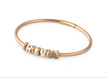 Rose gold bracelet with 'RIVA' charm on a white background