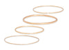 Set of gold permanent bangles on a white background