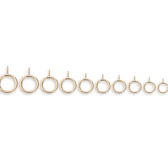 Set of gold invisible clasps on a white background
