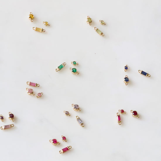 Small jewelry items with gemstones on a white background