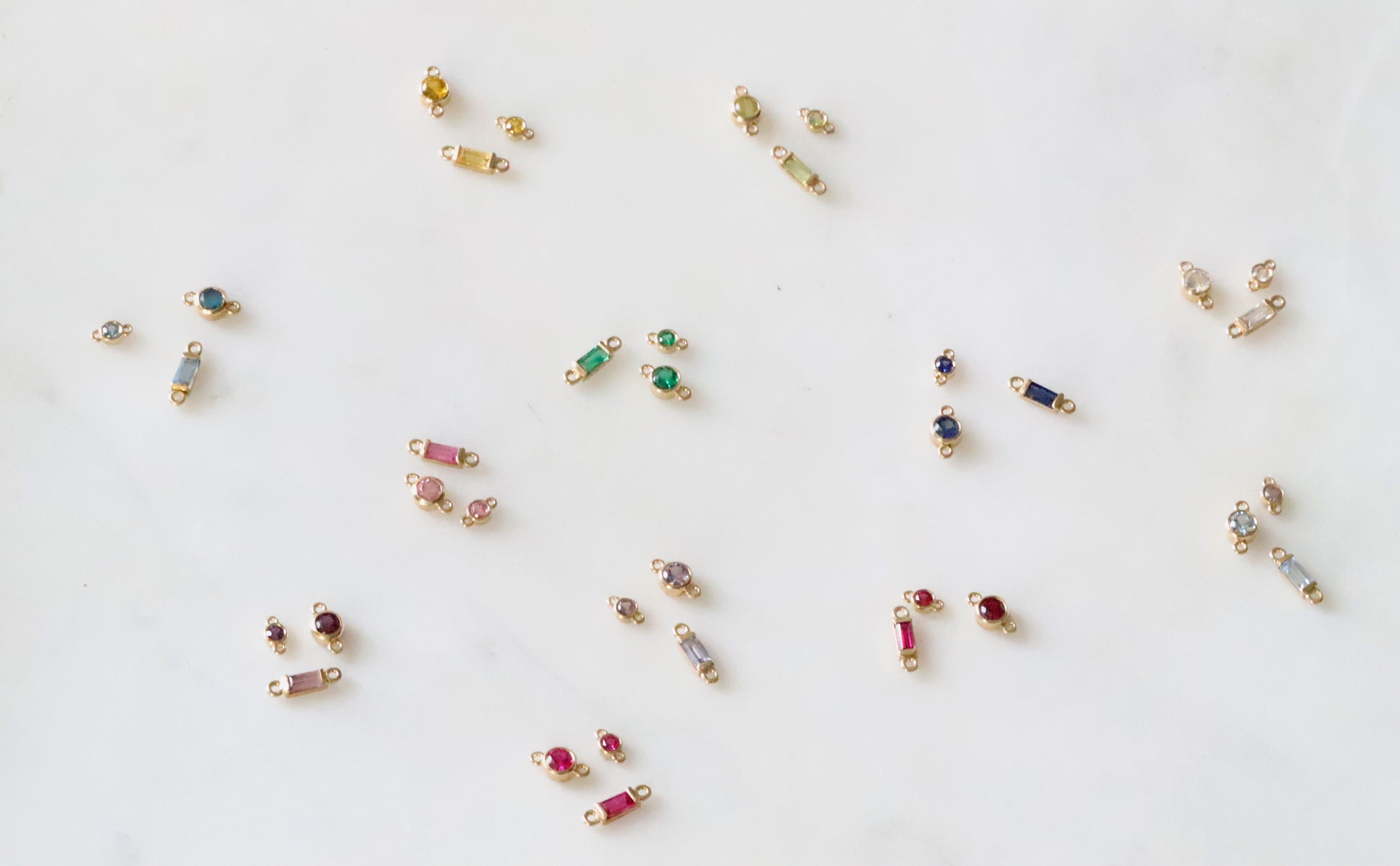 Small jewelry items with gemstones on a white background