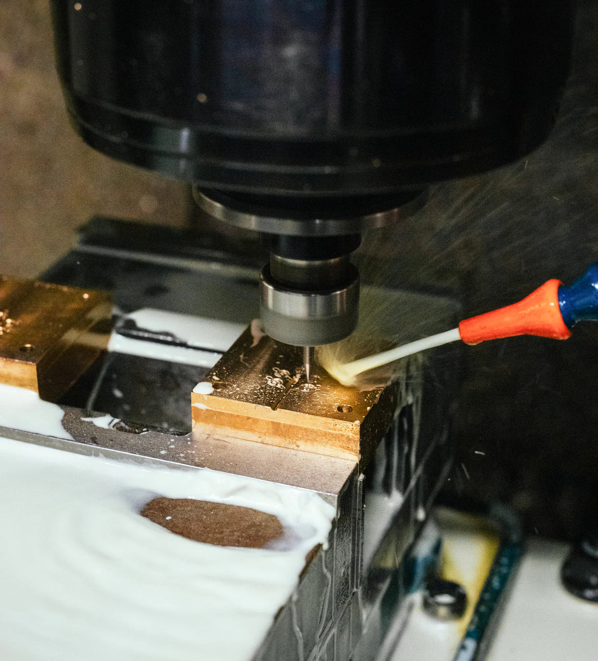 Tooling machine in operation with a tool bit approaching a workpiece