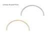 Two curved pieces of round permanent half cuffs, one silver and one gold, on a white background.