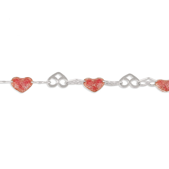 Silver chain with red heart-shaped charms on a white background
