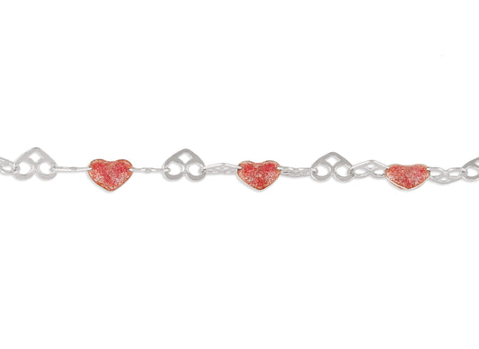 Silver chain with red heart-shaped charms on a white background
