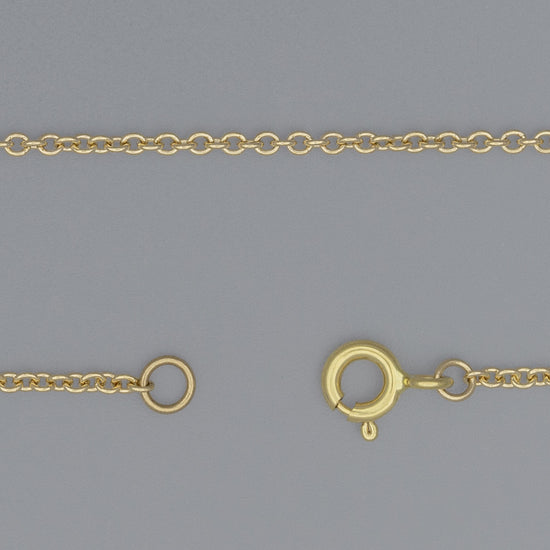A close-up image of a gold cable chain necklace with a focus on the extra-small circular links and the clasp.
