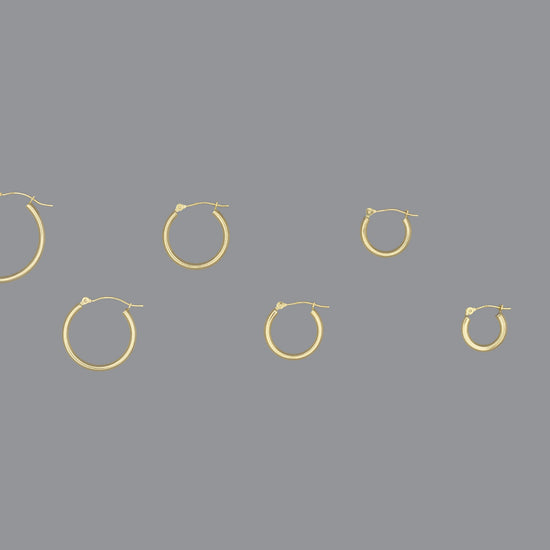 A collection of hoop earrings in ascending size order, made of 14KY gold, displayed against a grey background.