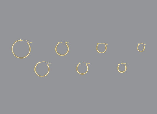 A collection of hoop earrings in ascending size order, made of 14KY gold, displayed against a grey background.